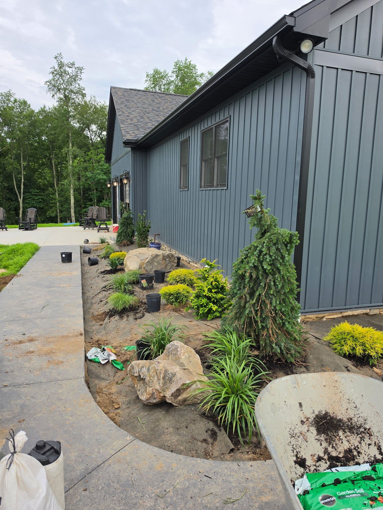 Fresh Garden Bed Installation in Progress Along a Modern Home image